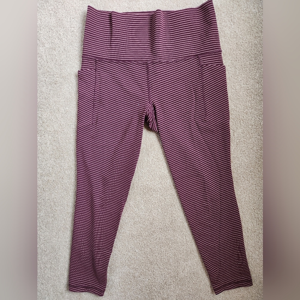 Athleta salutation 7/8 leggings, size small. Wine color with light pink stripes.